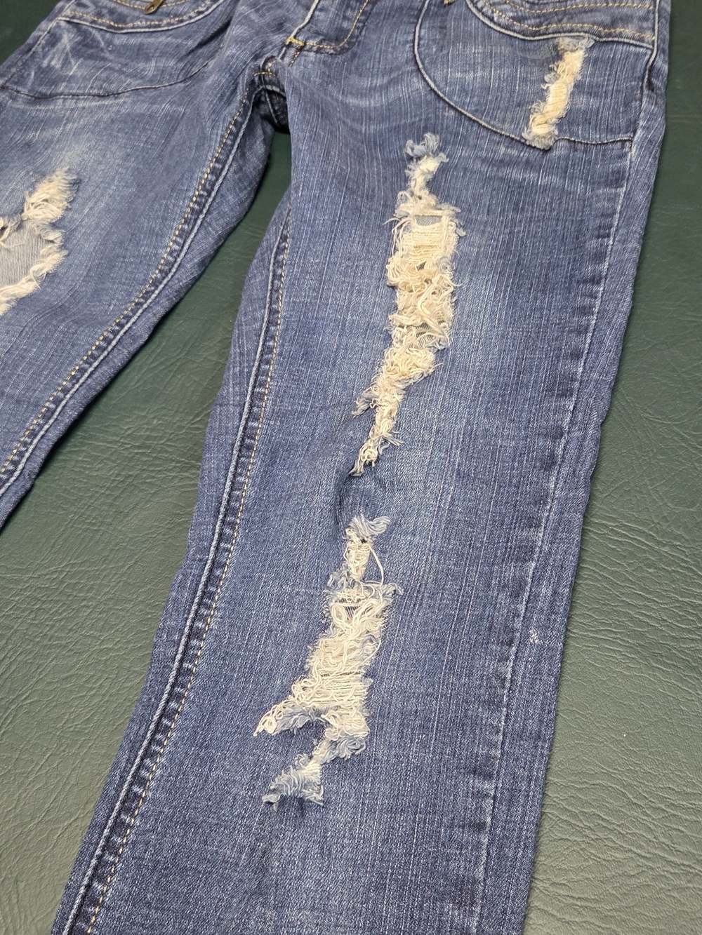 **Women’s Skinny Distressed Blue Jeans with Burgundy Patch Details** - Picture 10 of 11